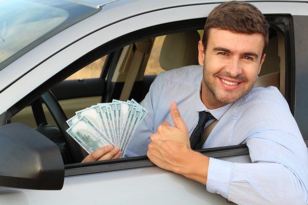 Man Holding Money to Buy a New Car — Chicago, IL — Illinois Insurance Center Inc