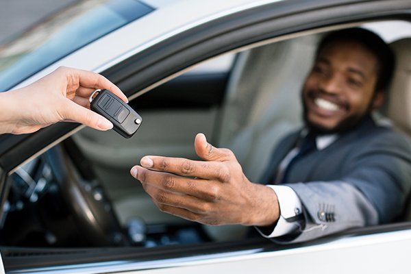 Professional Salesperson Giving Keys to New Car Owner — Chicago, IL — Illinois Insurance Center Inc