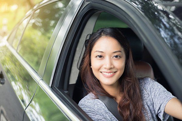 Beautiful Woman Smiling While Driving a Car — Chicago, IL — Illinois Insurance Center Inc
