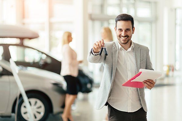Elegant Salesperson Working at Car Dealership — Chicago, IL — Illinois Insurance Center Inc