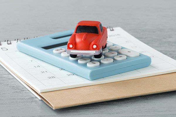 Toy Car on Calculator and Calendar — Chicago, IL — Illinois Insurance Center Inc