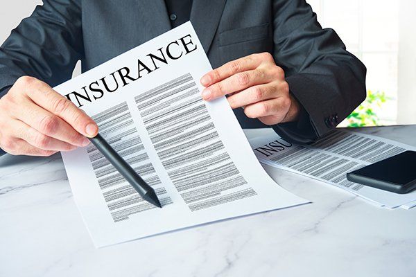 Insurance Agent Showing a Contract to Sign — Chicago, IL — Illinois Insurance Center Inc
