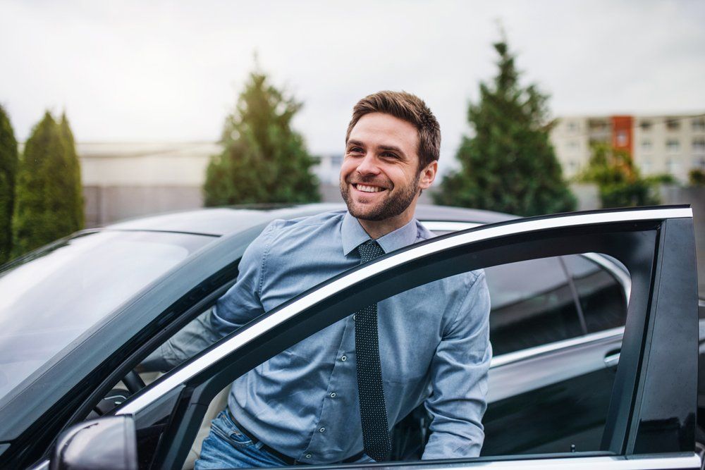 Happy Young Man Getting Out of Car — Hillside, IL — Illinois Insurance Center Inc