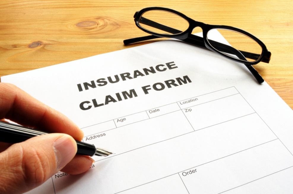 Insurance Claim Form And Eye Glass On Table — Chicago, IL — Illinois Insurance Center Inc