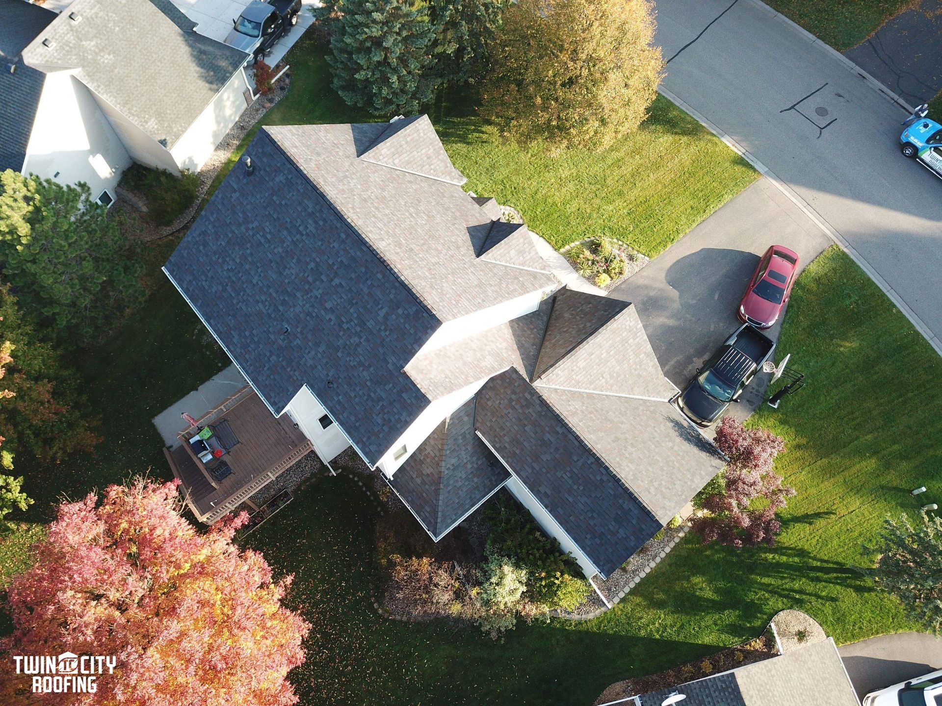 An aerial view of a house with a black roof