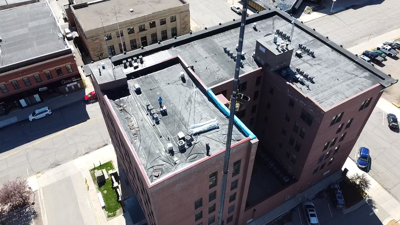 An aerial view of a large brick building in a city.