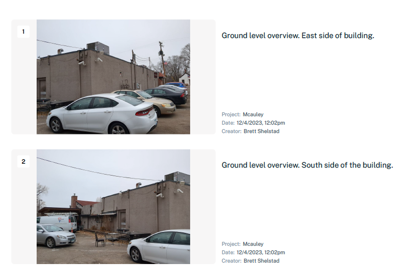 A white car is parked in front of a building.