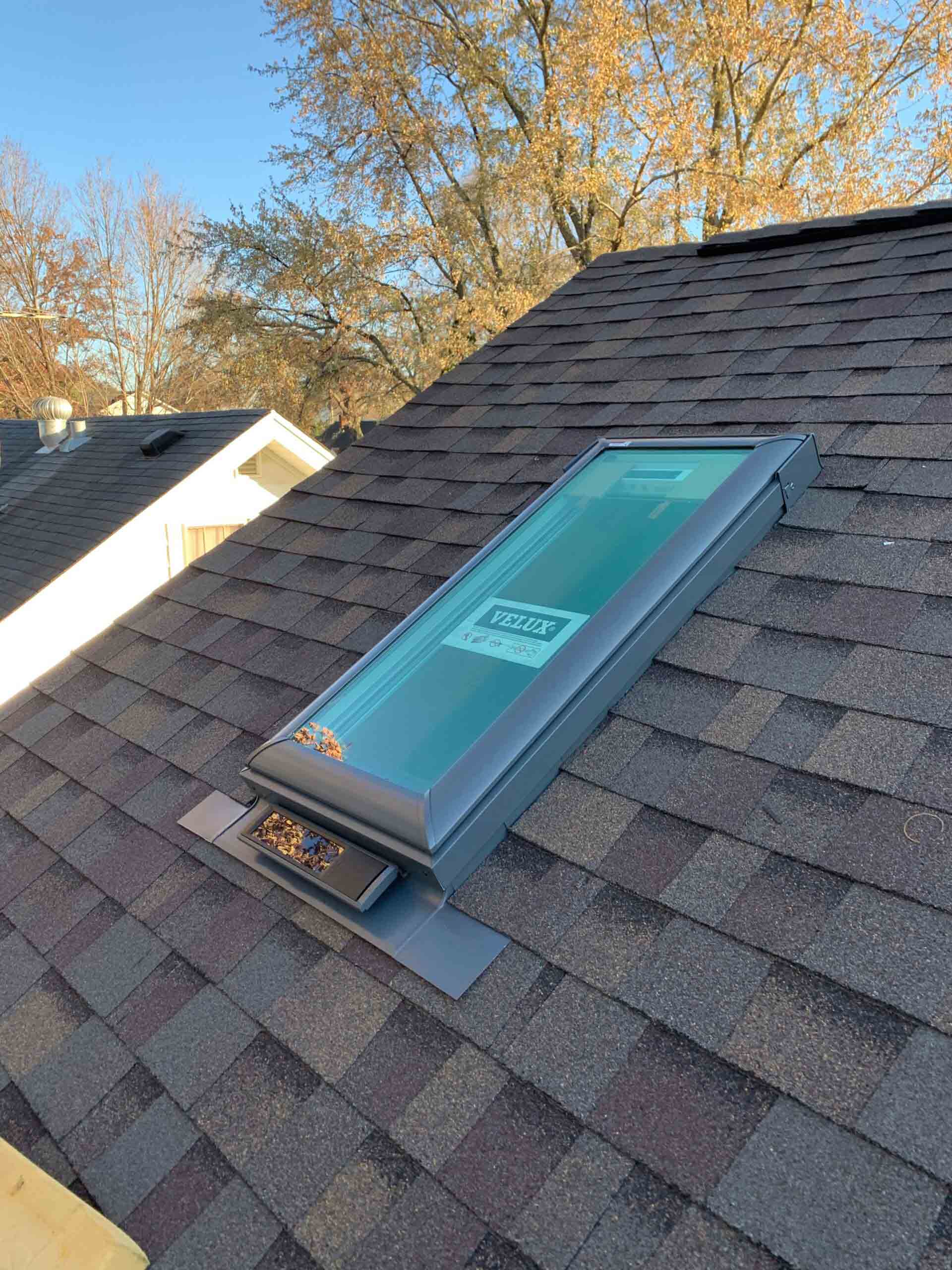 A skylight is sitting on top of a roof.