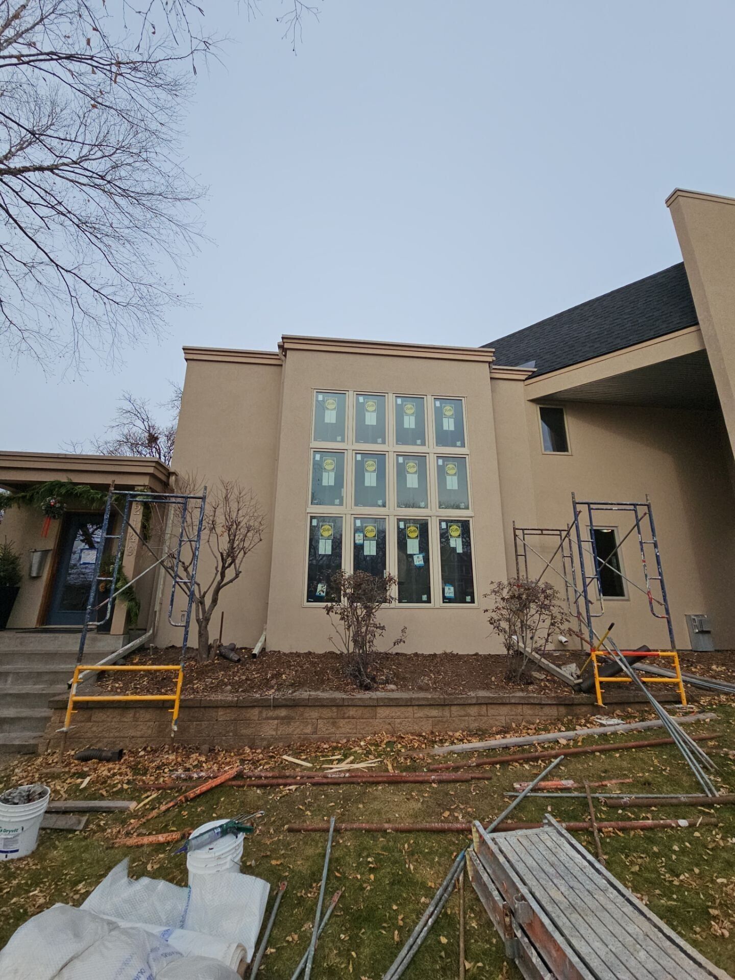 A large house with a lot of windows is being built.