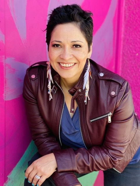 Picture of woman smiling standing in front of colorful background