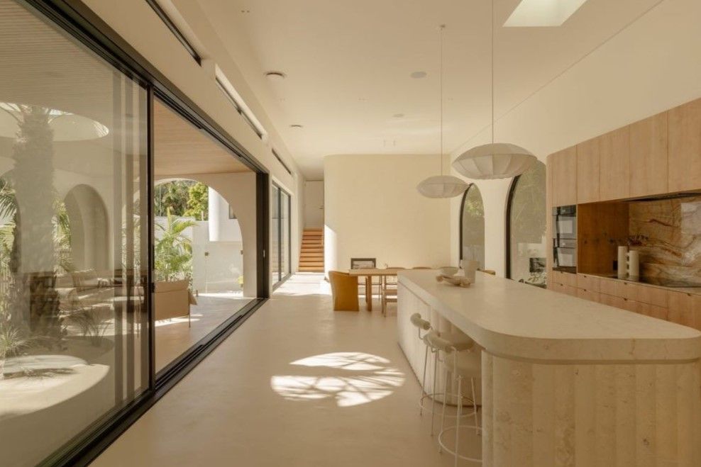 A Long, Bright Kitchen With a Wooden Island and Sliding Glass Doors — Architectural Glass Solutions QLD in Cooroy, QLD