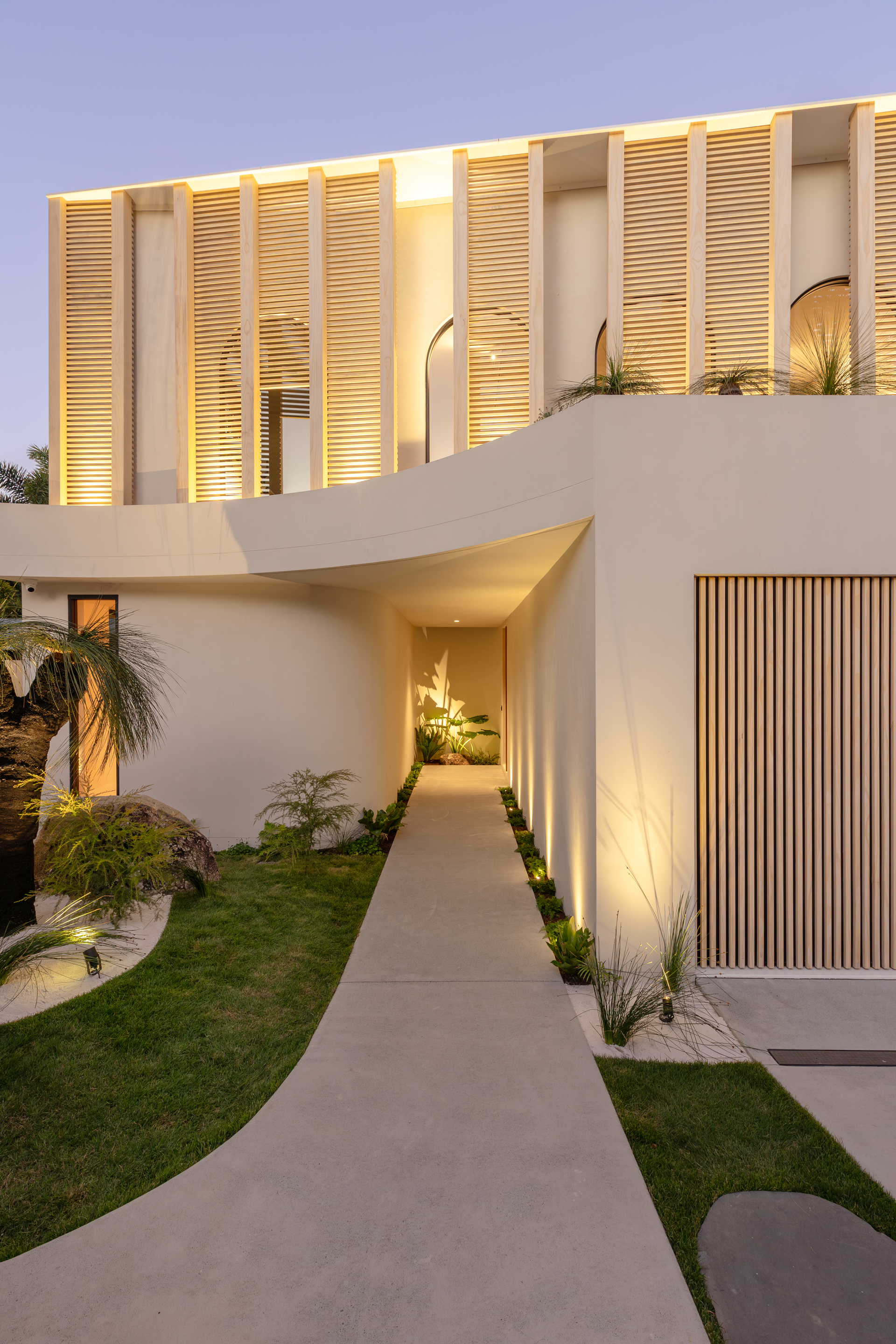 Modern House With Cream Walls, Wooden Slats, and a Long Pathway — Architectural Glass Solutions QLD in Cooroy, QLD