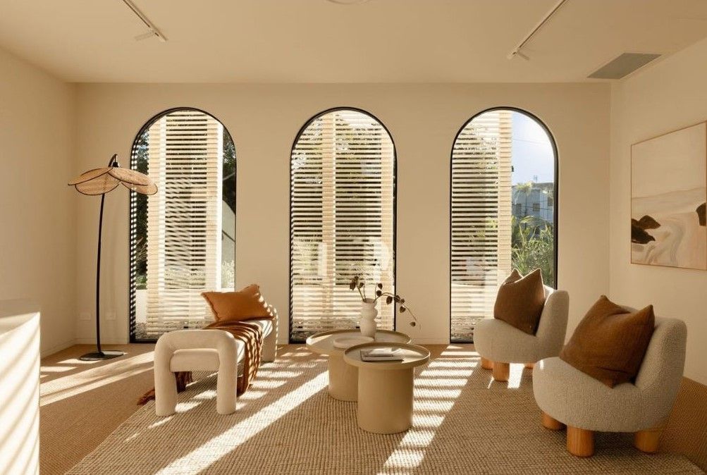 an Airy Room With Arched Windows, Filled With Sunlight and Neutral Tones — Architectural Glass Solutions QLD in Cooroy, QLD