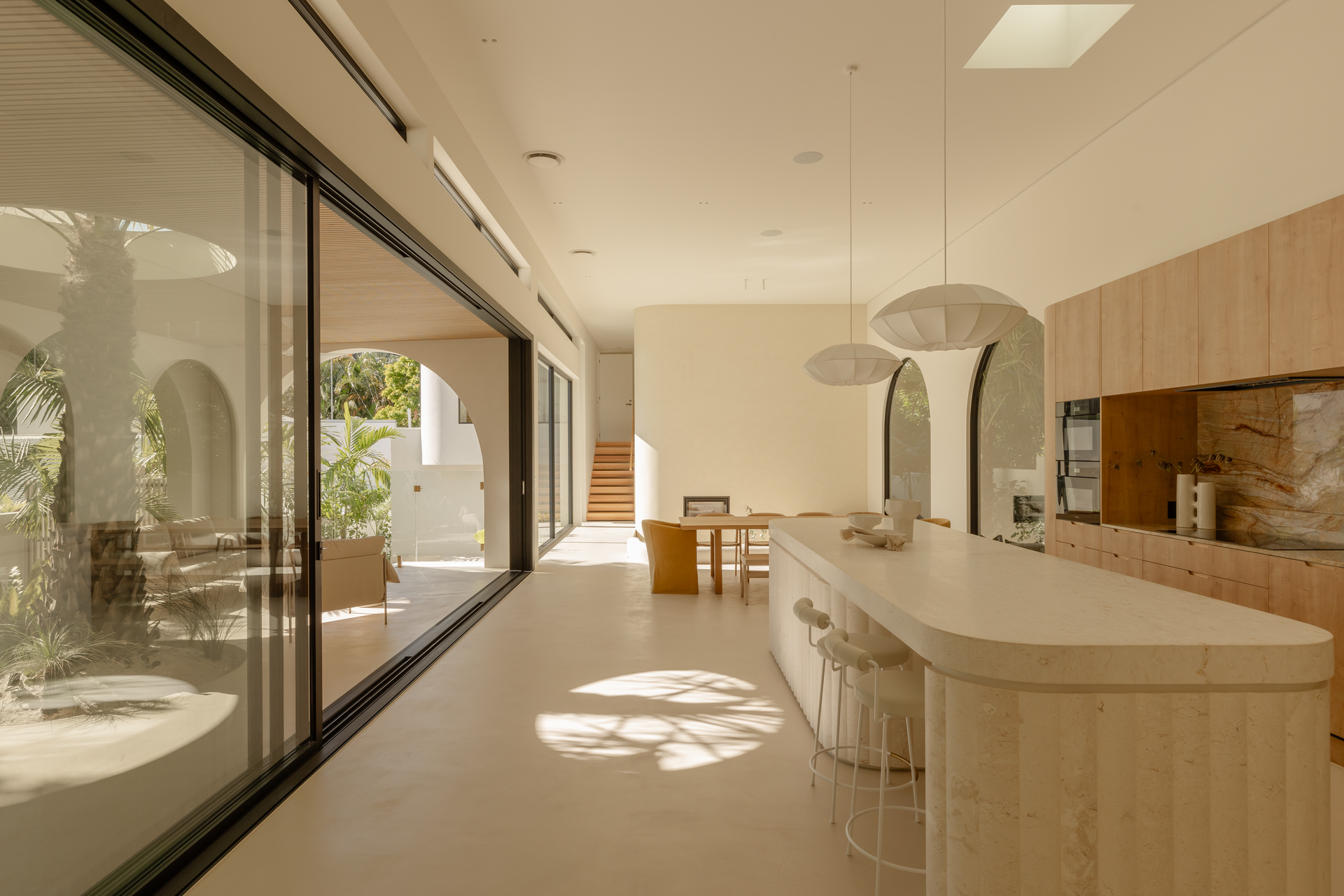 Spacious Kitchen With Island, Sliding Glass Doors, and Wood Cabinetry — Architectural Glass Solutions QLD in Cooroy, QLD