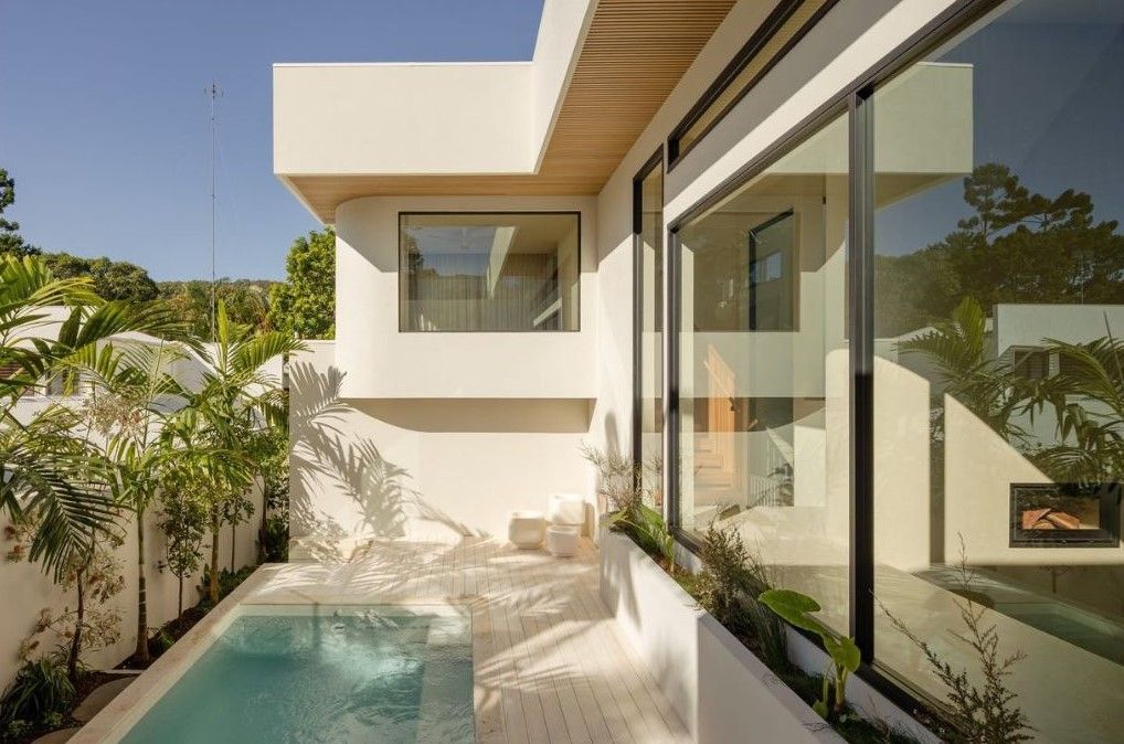 Modern White House With a Small Pool, Large Windows, and Tropical Plants — Architectural Glass Solutions QLD in Cooroy, QLD
