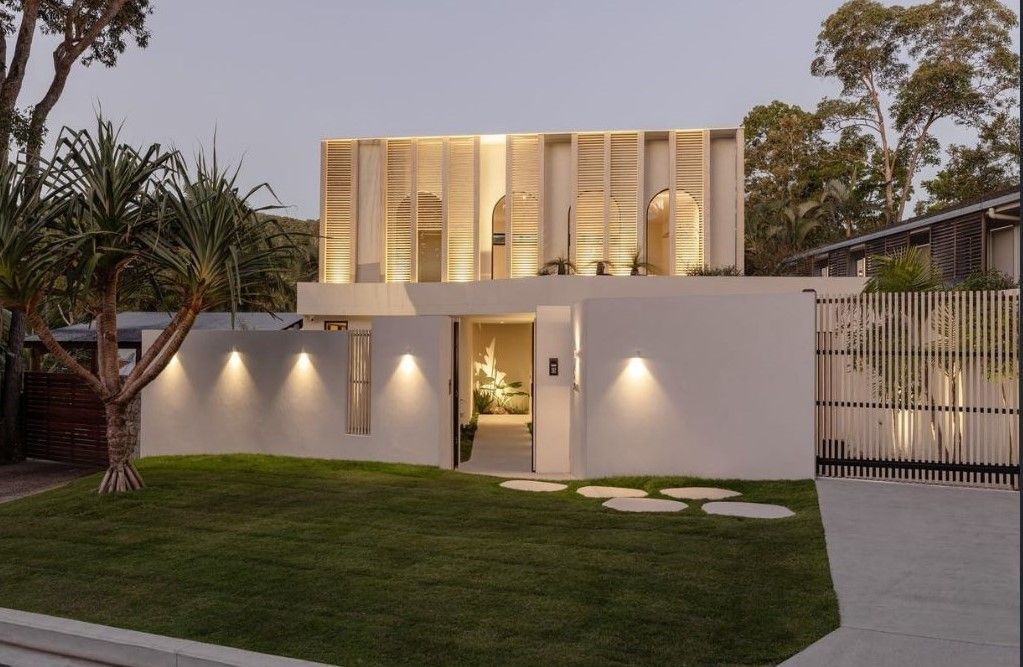 Modern House With Wooden Screen Facade, Illuminated by Warm Lights at Dusk — Architectural Glass Solutions QLD in Cooroy, QLD