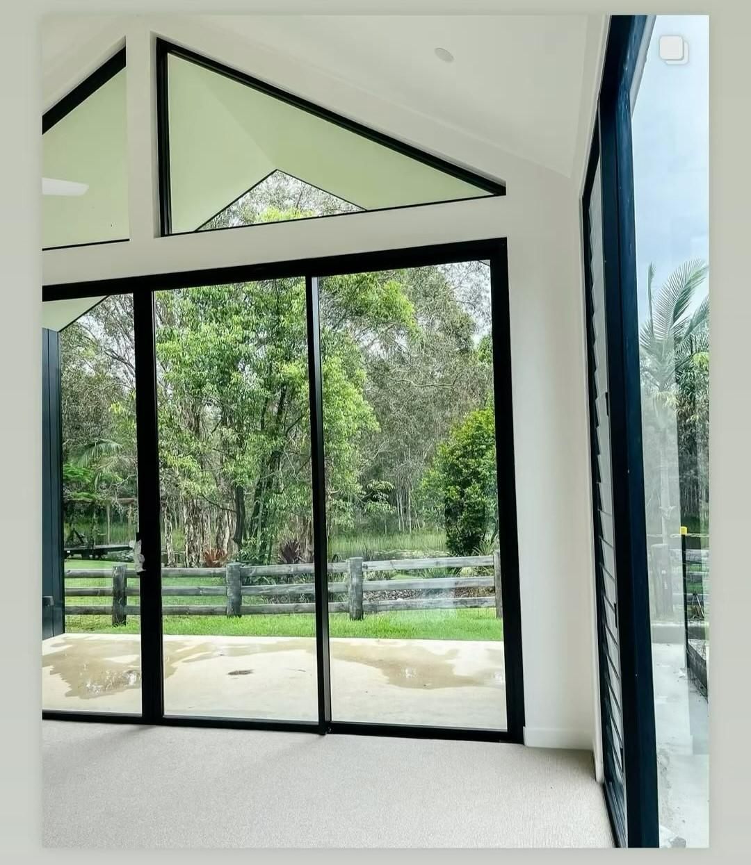 Interior View of a Modern Room With Large Black-framed — Architectural Glass Solutions QLD in Cooroy, QLD
