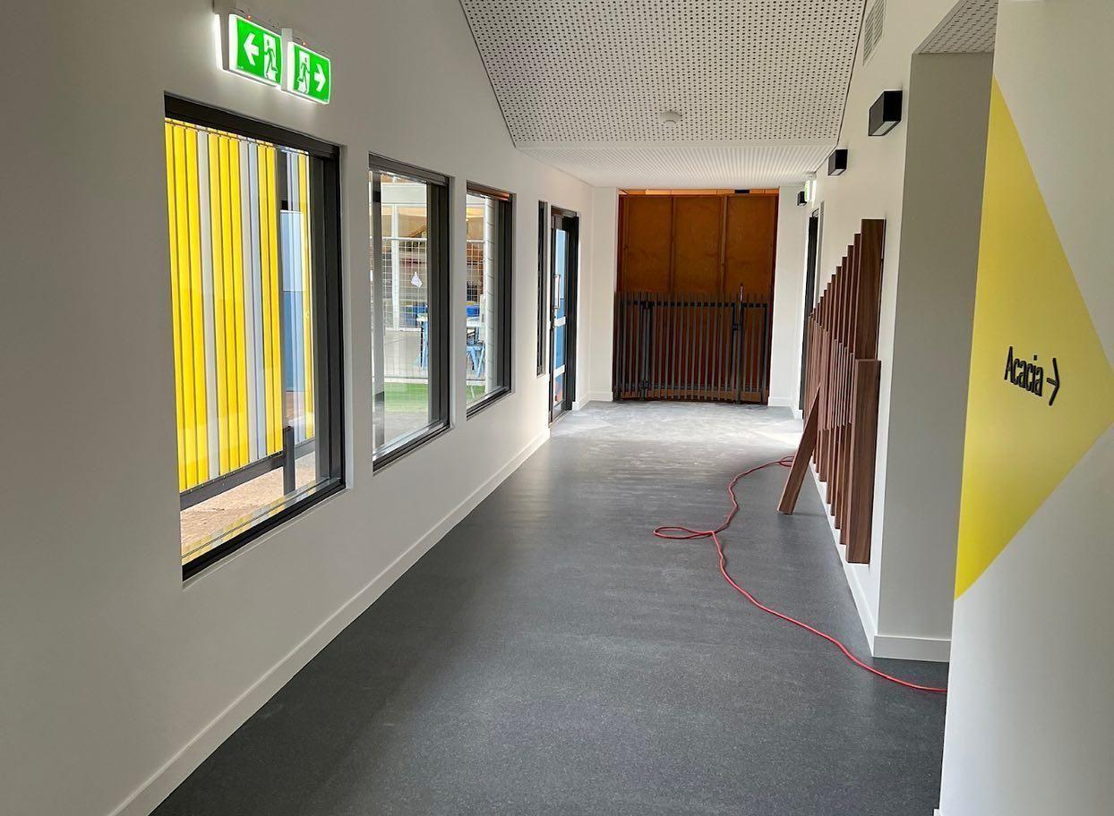 A Long Hallway with A Lot of Windows and A Red Cord — Architectural Glass Solutions QLD in Cooroy, QLD