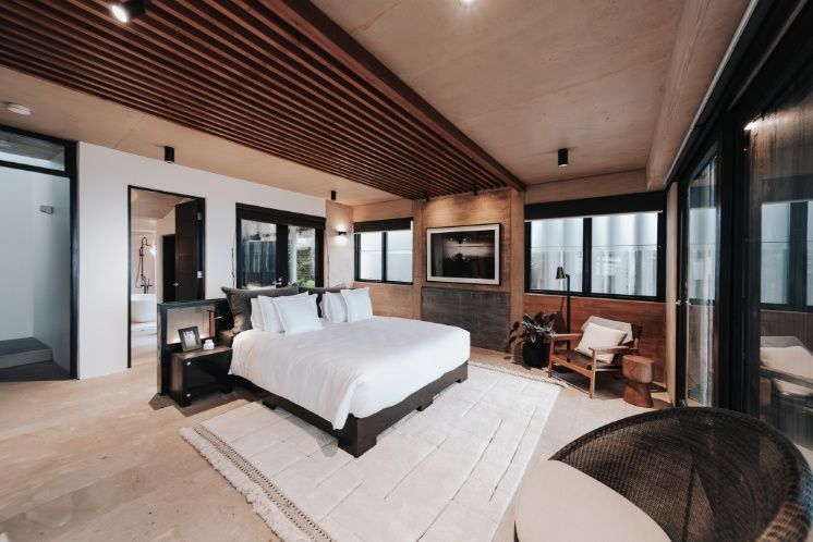 A Large Bedroom With a King Size Bed and Lots of Windows — Architectural Glass Solutions QLD in Cooroy, QLD