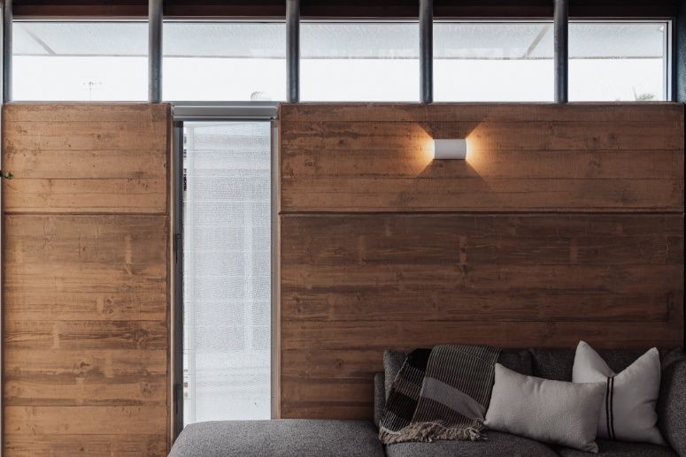 A Living Room With a Couch and a Wooden Wall — Architectural Glass Solutions QLD in Cooroy, QLD