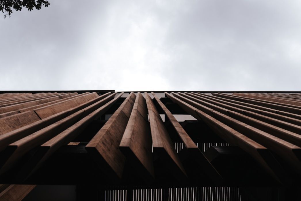 Looking Up at a Wooden Building With a Cloudy Sky in the Background   — Architectural Glass Solutions QLD in Cooroy, QLD