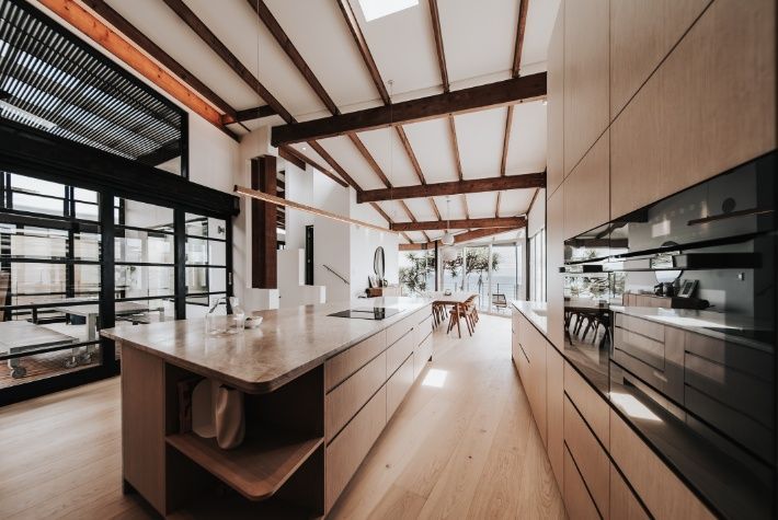 A Kitchen With a Large Island in the Middle of It — Architectural Glass Solutions QLD in Cooroy, QLD