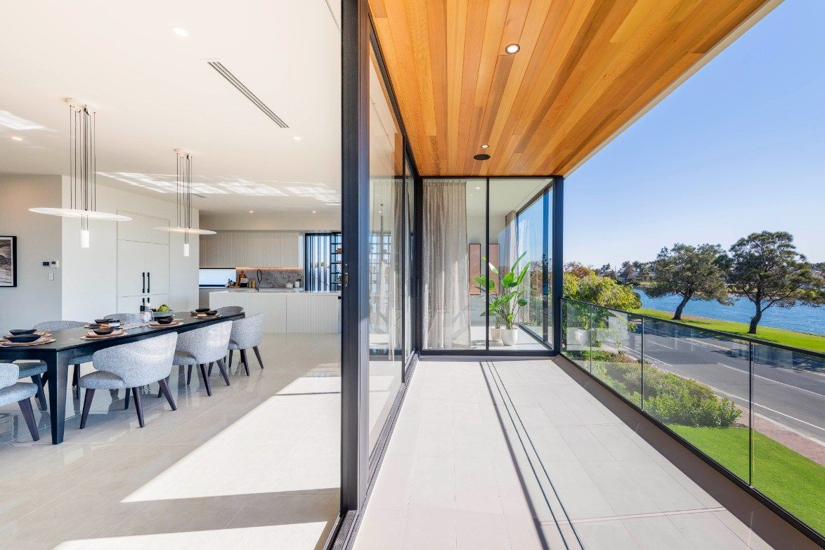 Modern Dining Area With Waterfront Balcony — Architectural Glass Solutions QLD in Cooroy, QLD