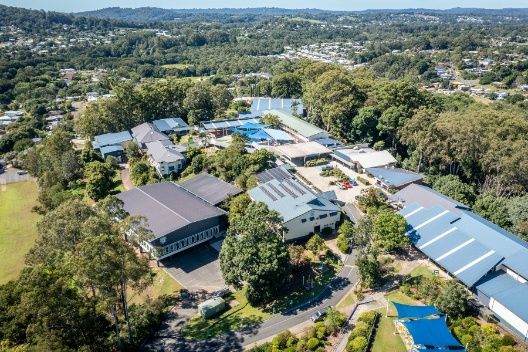 An Aerial View of a School Surrounded by Trees and Buildings — Architectural Glass Solutions QLD in Cooroy, QLD