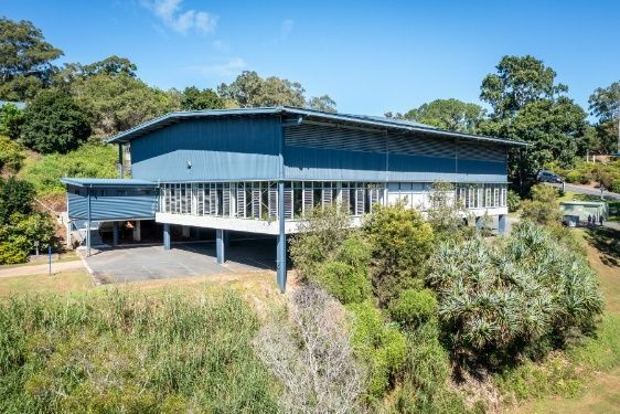 A Large Building on Top of a Hill Surrounded by Trees — Architectural Glass Solutions QLD in Cooroy, QLD