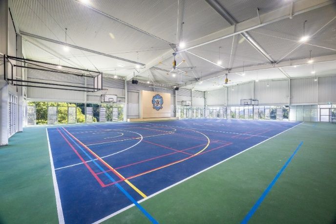 A Indoor Basketball Court With a Basketball Hoop in the Background — Architectural Glass Solutions QLD in Cooroy, QLD