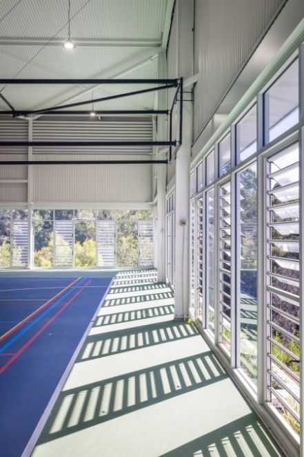 A Gym With a Blue Floor and a Lot of Windows — Architectural Glass Solutions QLD in Cooroy, QLD