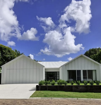White Modern House With a Driveway, Lawn, and Blue Sky With Clouds — Architectural Glass Solutions QLD in Cooroy, QLD