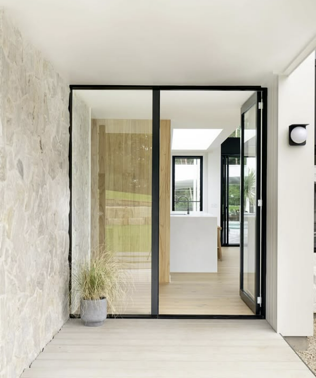 Exterior of Modern Home With Open Black-framed Doors — Architectural Glass Solutions QLD in Cooroy, QLD