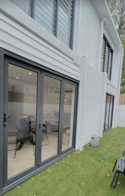 Two-story White Building With Large, Dark-framed Glass Doors and Windows — Architectural Glass Solutions QLD in Cooroy, QLD