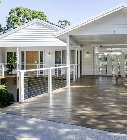 White House With a Large Wooden Deck, Carport, and Balcony — Architectural Glass Solutions QLD in Cooroy, QLD