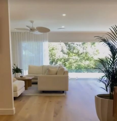 A Bright, Modern Living Room With White Sofa, Wooden Floors, Large Window — Architectural Glass Solutions QLD in Cooroy, QLD