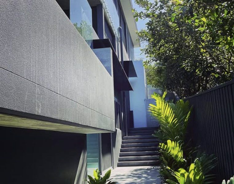 Modern Building Exterior With Dark Grey Siding and Stairs — Architectural Glass Solutions QLD in Cooroy, QLD