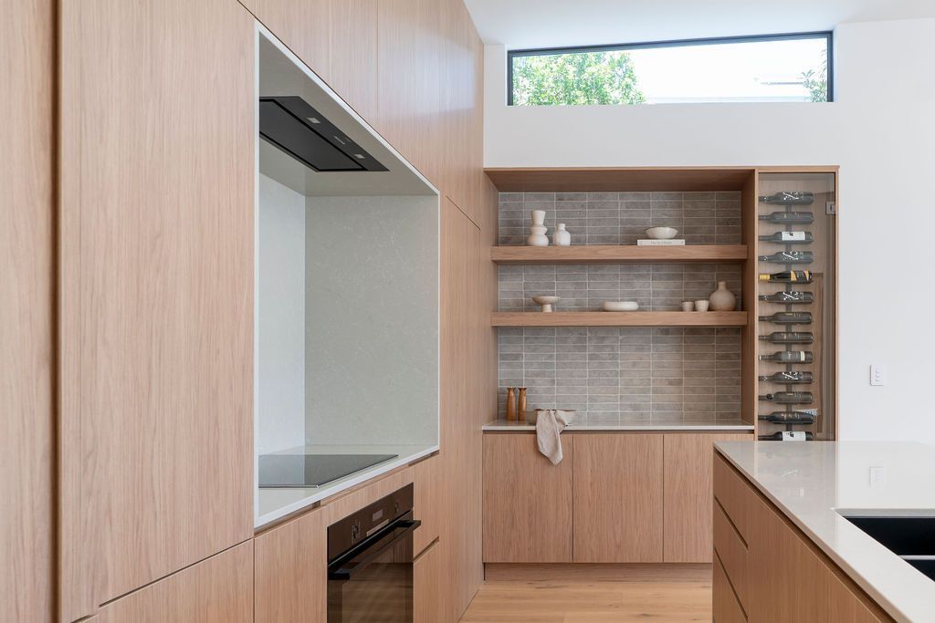 Modern kitchen with light wood cabinetry, white countertops — Architectural Glass Solutions QLD in Cooroy, QLD