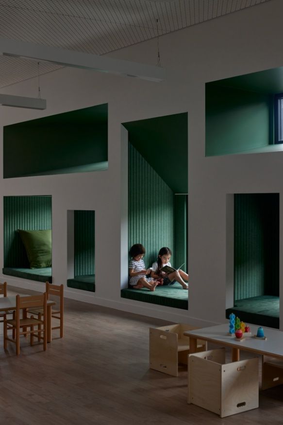 Two Children Are Reading Books in a Room With Green Walls — Architectural Glass Solutions QLD in Cooroy, QLD