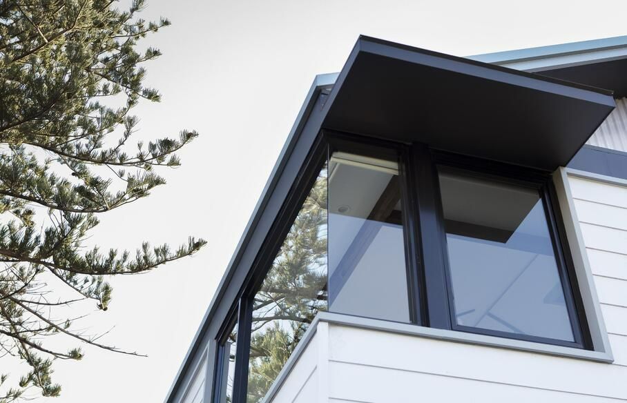 Black Awning Shades Window of a White House With Black Trim — Architectural Glass Solutions QLD in Cooroy, QLD