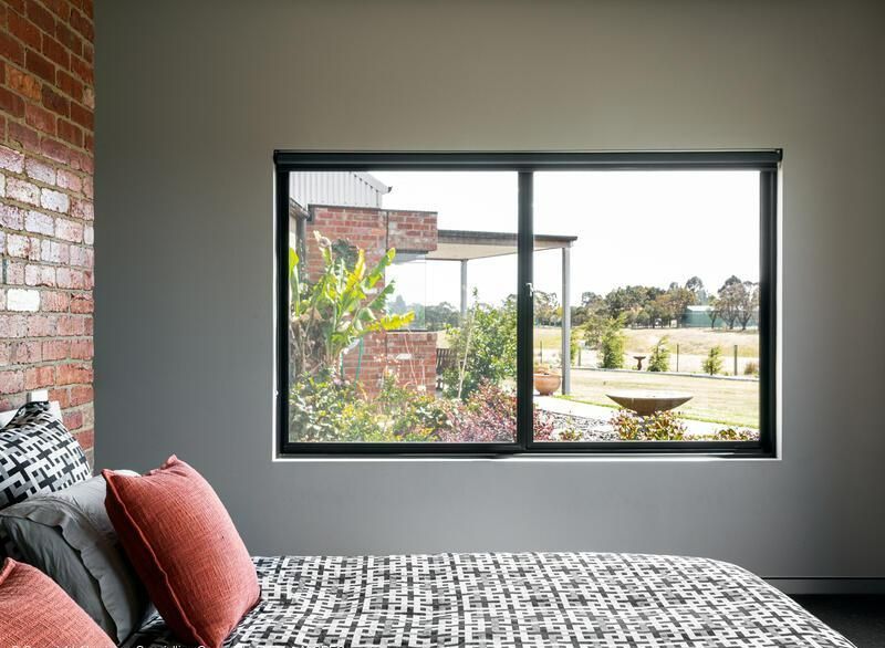 Bedroom With a Large Window Overlooking a Yard — Architectural Glass Solutions QLD in Cooroy, QLD