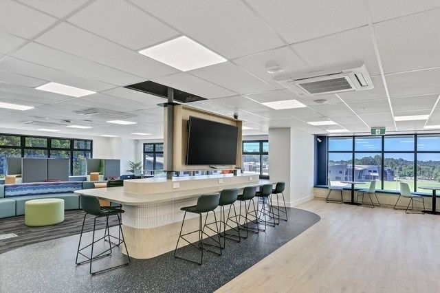 A Large Room With a Long Table and Stools — Architectural Glass Solutions QLD in Cooroy, QLD