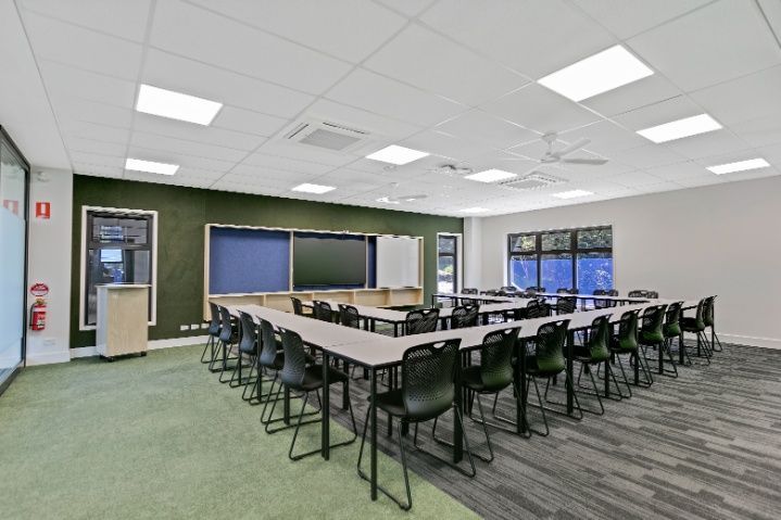 A Large Room With Tables and Chairs in a Classroom — Architectural Glass Solutions QLD in Cooroy, QLD
