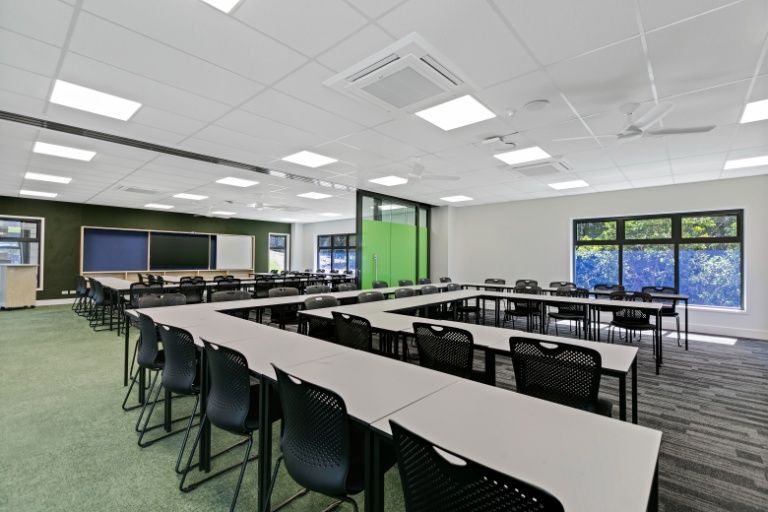 A Large Classroom With a Lot of Tables and Chairs — Architectural Glass Solutions QLD in Cooroy, QLD