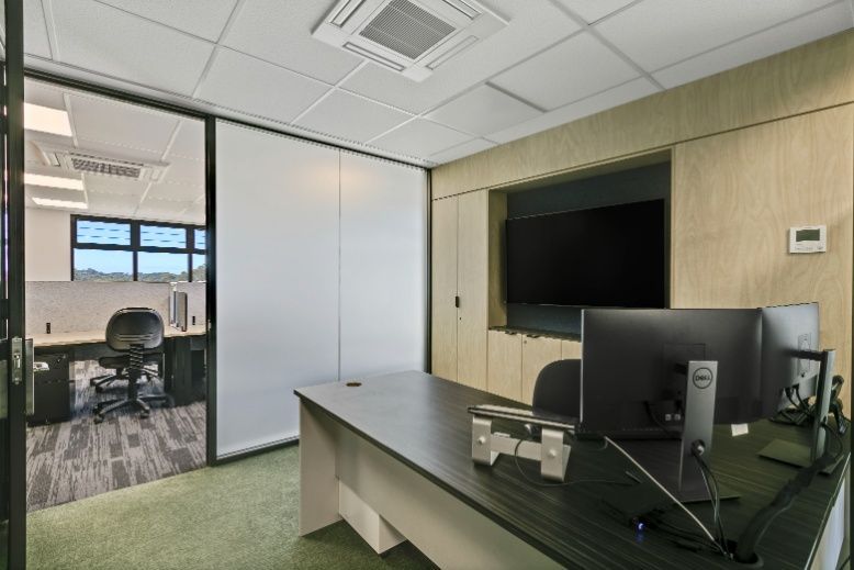 A Computer Monitor is Sitting on a Desk in an Office — Architectural Glass Solutions QLD in Cooroy, QLD