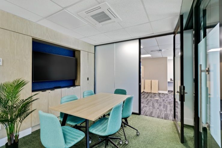 A Conference Room With a Table and Chairs and a Flat Screen Tv — Architectural Glass Solutions QLD in Cooroy, QLD