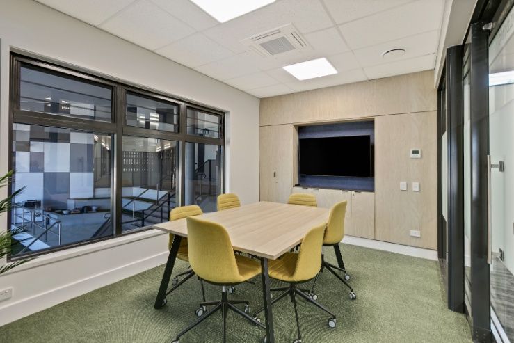 A Conference Room With a Table and Chairs and a Television — Architectural Glass Solutions QLD in Cooroy, QLD