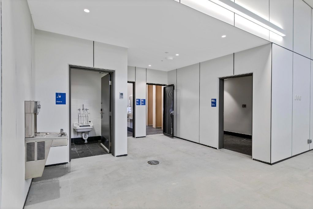 A Large Empty Room With White Walls and a Sink — Architectural Glass Solutions QLD in Cooroy, QLD