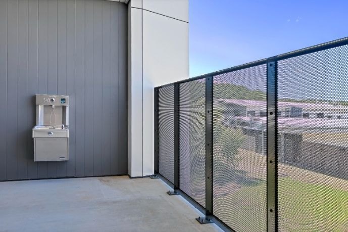 A Balcony With a Fence and a Water Fountain — Architectural Glass Solutions QLD in Cooroy, QLD