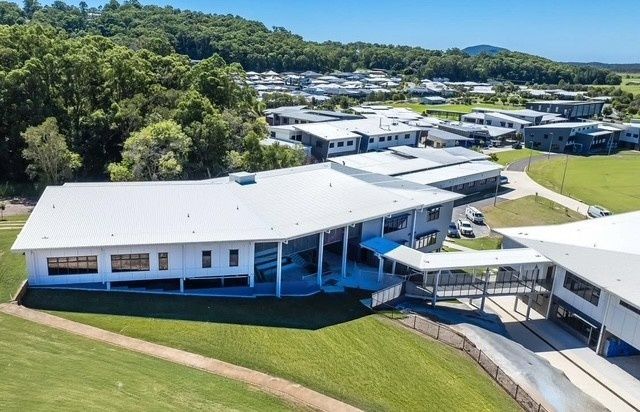 An Aerial View of a Large White Building Surrounded by Trees — Architectural Glass Solutions QLD in Cooroy, QLD